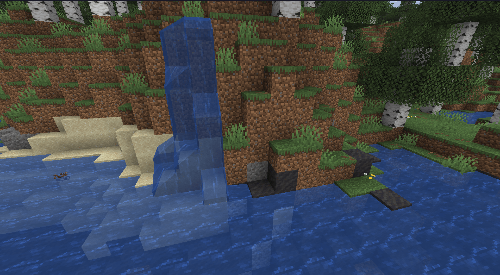 A waterfall, with some gravel and mud blocks below the waterline and across the shores showing signs of erosion over time. Behind the waterfall is a birch forest.