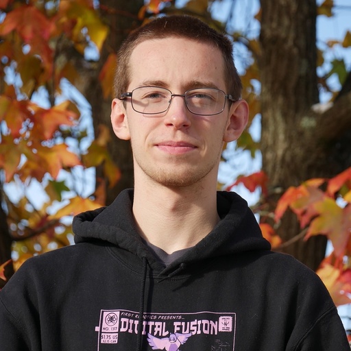 kieran with a white and gray spotted kitten with a grainy background and star dust